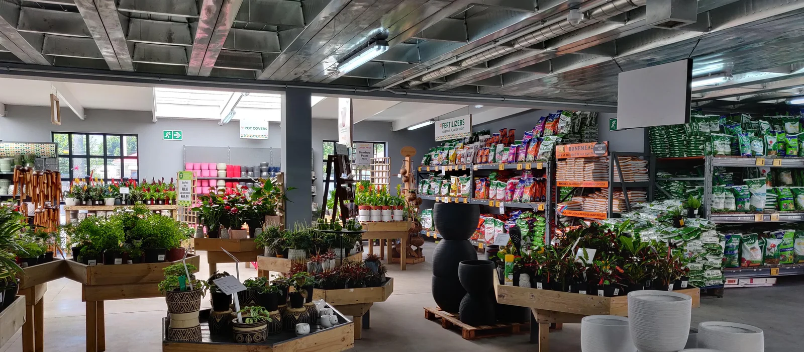 Garden center retail floor with pots, fertilizer, and supplies aisles